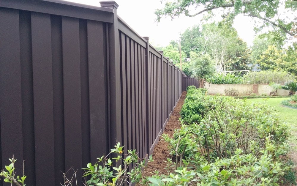 Project Spotlight – AAA Quality Fence – Lafayette 2 A Trex composite fence in Lafayette, Louisiana separating a homeowner property from a school