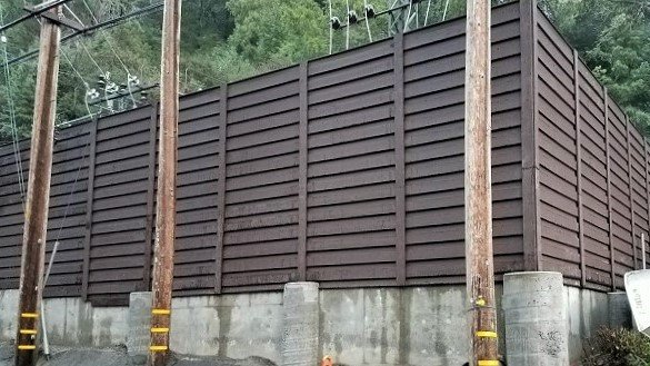 utility-enclosure-trex-fencing-california A tall Trex Horizons horizontal fence built around a substation.