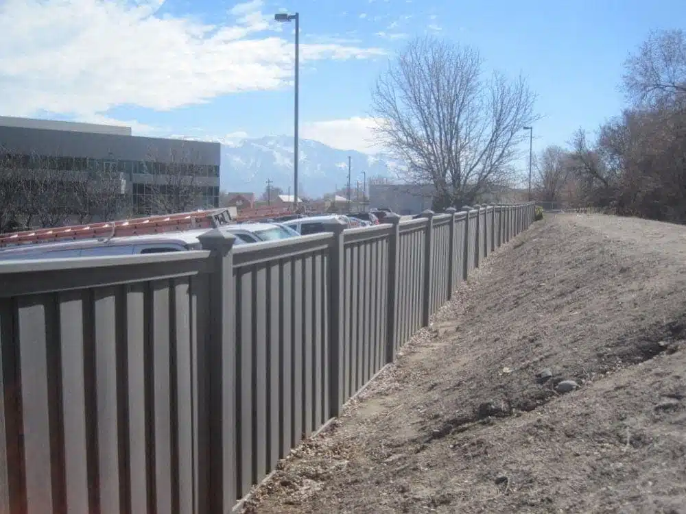 Nelson Labs - Trex Seclusions Winchester Grey A Trex fence next to a berm and path