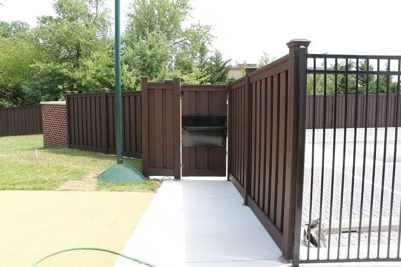 Goddard School Trex Fencing and Gates A Trex Fence with a gate. The gate has a panic bar panel to allow restricted access into the school property.