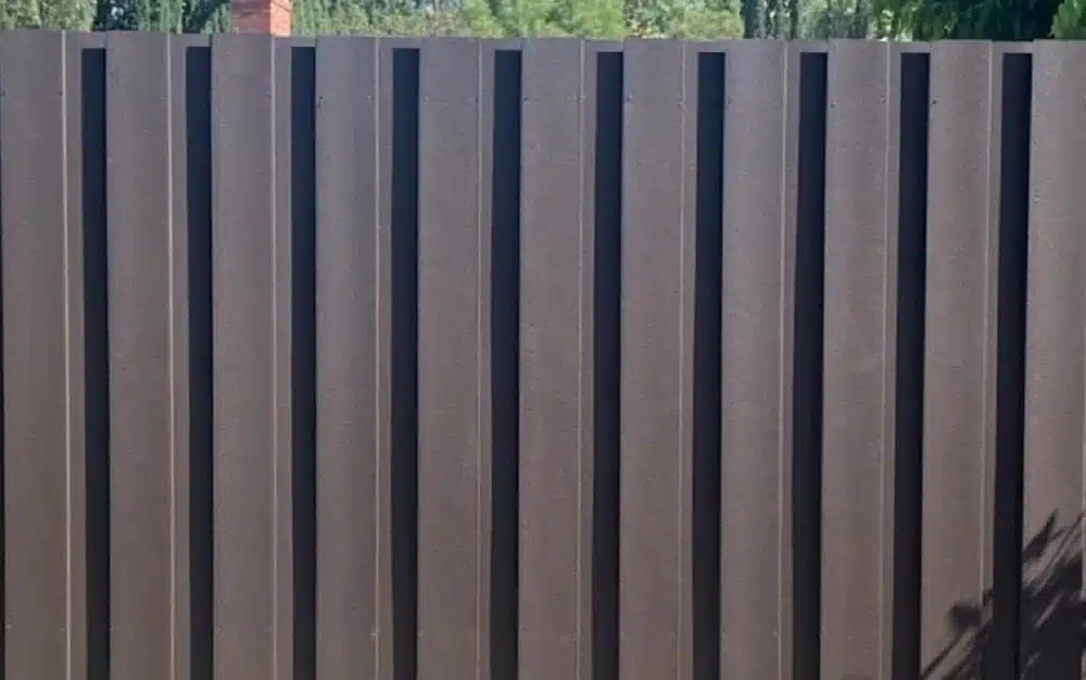 trex-board-on-board-fence-front-side Trex board-on-board fence pickets attached to wood fencing.