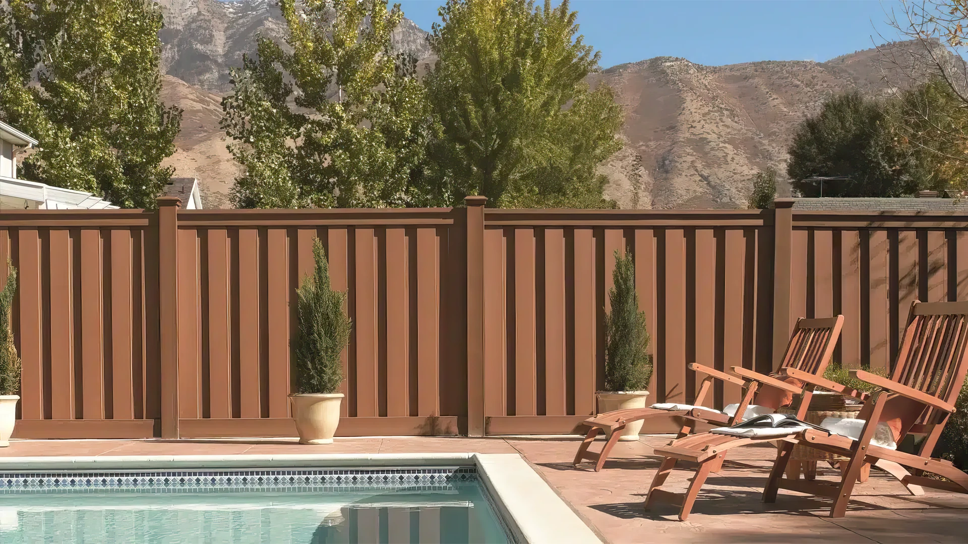 hero image of Trex composite fencing in Saddle Color Seclusions style in front of a pool.